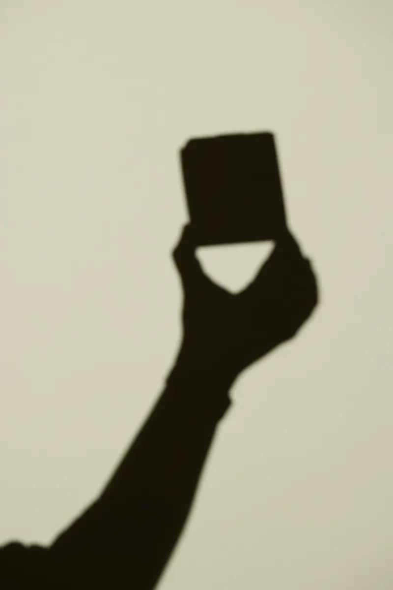 Der Schatten einer Hand, die eine Femieko-Produktschachtel hält